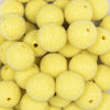 Close up view of a pile of 20mm Yellow Sugar Glass Bubblegum Beads