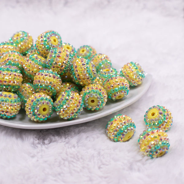 Front view of a pile of 20mm Yellow Pastel Striped Rhinestone AB Bubblegum Beads