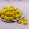 Front view of a pile of 20mm Yellow Faceted Opaque Bubblegum Beads
