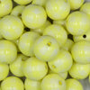 Close up view of a pile of 20mm Pastel Yellow Plaid Print Bubblegum Beads