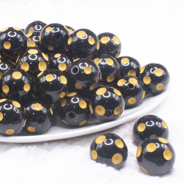 front view of a pile of 20mm Yellow Polka Dots on Black Bubblegum Beads