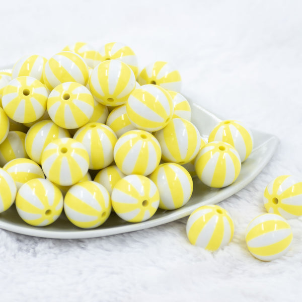 Front view of a pile of 20mm Yellow with White Stripe Beach Ball Bubblegum Beads