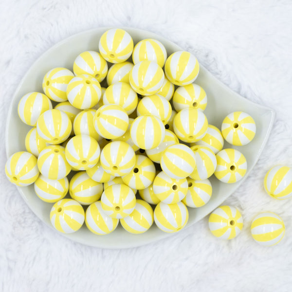Top view of a pile of 20mm Yellow with White Stripe Beach Ball Bubblegum Beads