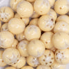 close up view of a pile of 20mm Yellow with White Marble Flower Bubblegum Beads