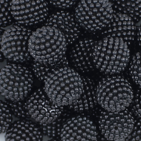 Close up view of a pile of 20mm Ball Bead Black Bubblegum Beads