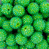 Close up view of a pile of 20mm Green Apple Rhinestone AB Bubblegum Beads