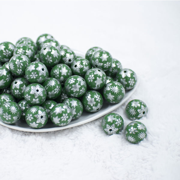 Front view of a pile of 20mm Silver Snowflake Print on Green Acrylic Bubblegum Beads