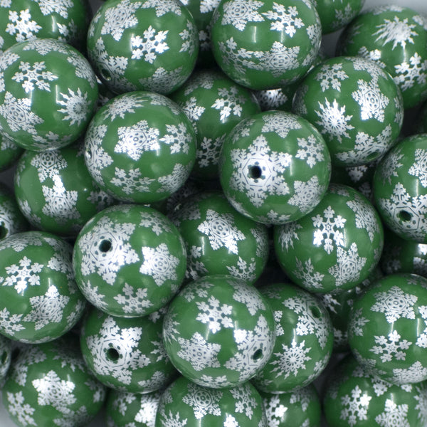 Close up view of a pile of 20mm Silver Snowflake Print on Green Acrylic Bubblegum Beads