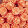 Close up view of a pile of 20mm Ball Bead Orange Bubblegum Beads