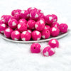 front view of pink with white hears 20mm Bubblegum Bubblegum Beads on a white plate with white background