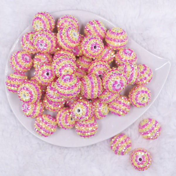 Top view of a pile of 20mm Pink & Yellow Striped Rhinestone AB Bubblegum Beads