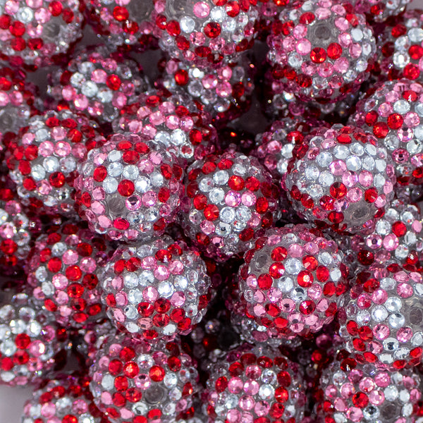 Close up view of a pile of 20mm Red, Pink, & Silver Confetti Rhinestone AB Bubblegum Beads