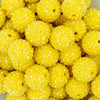 Close up view of a pile of 20mm Sunshine Yellow Rhinestone AB Bubblegum Beads