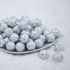 Front view of a pile of 20mm Silver Snowflake Print on White Acrylic Bubblegum Beads