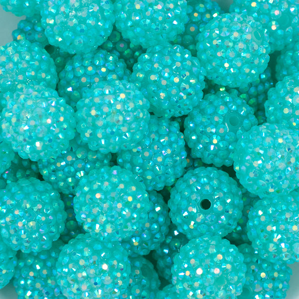 zoomed view of a pile of 20mm Chunky Bubblegum Beads in a Aqua Blue with prism Rhinestone finish