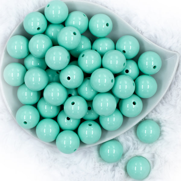 top view of a pile of 20mm Aqua Blue Solid Chunky Bubblegum Beads in white dish