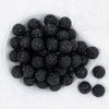 top view of 20mm Black Glimmer Rhinestone AB Chunky Bubblegum Bead in white dish