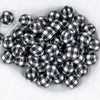 top view of a dish containing many 20mm Black & White Plaid Print Chunky Acrylic Bubblegum Beads in a white dish