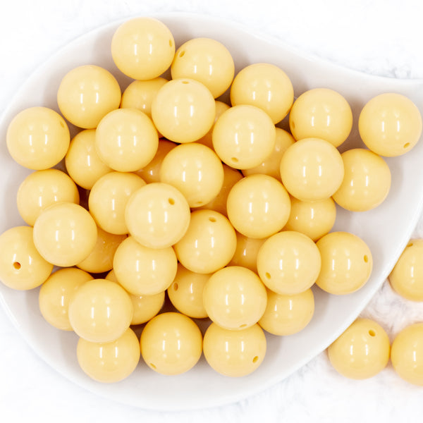 Top view of a pile of 20mm Solid colored Blonde Yellow Shiny Beads