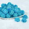 front view of a plate containing a pile of 20mm light blue super sparkly Rhinestone AB Chunky Bubblegum Beads