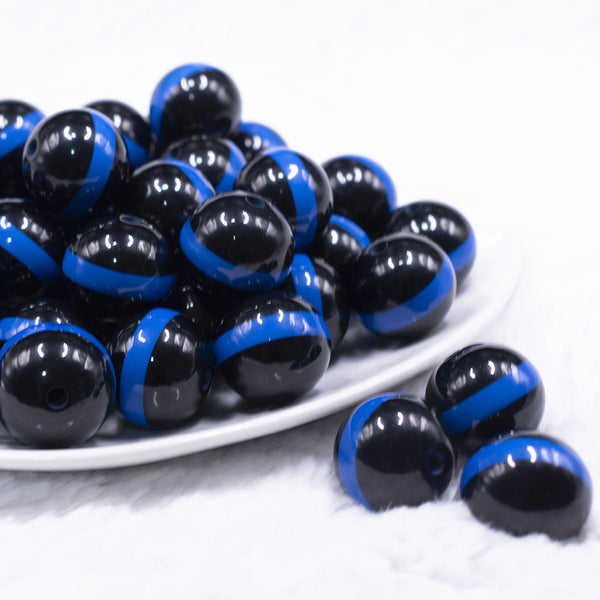 front view of a pile of 20mm Blue Band on Black Bubblegum Beads