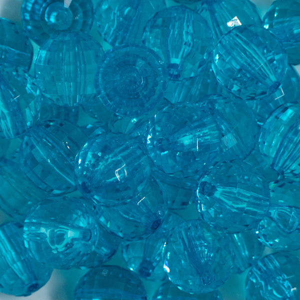 Close up view of a pile of 20mm Blue Transparent Disco Faceted Pearl Bubblegum Beads