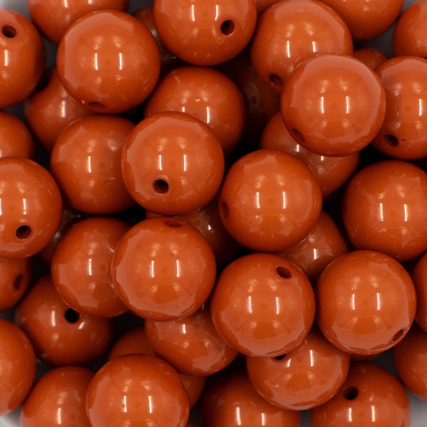 close up view of a pile of 20mm Burnt Orange Solid Bubblegum Beads