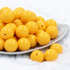 front view of a pile of 20mm Butter Yellow Solid Chunky Bubblegum Beads on a white dish