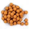 top view of a pile of 20mm Camel Tan Solid Bubblegum Beads
