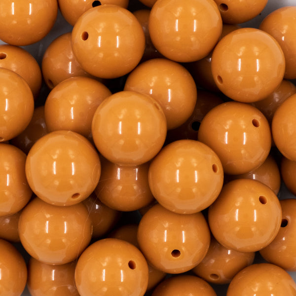 close up view of a pile of 20mm Camel Tan Solid Bubblegum Beads