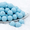 front view of 20mm Carolina Blue Chunky Bubblegum Beads in white dish