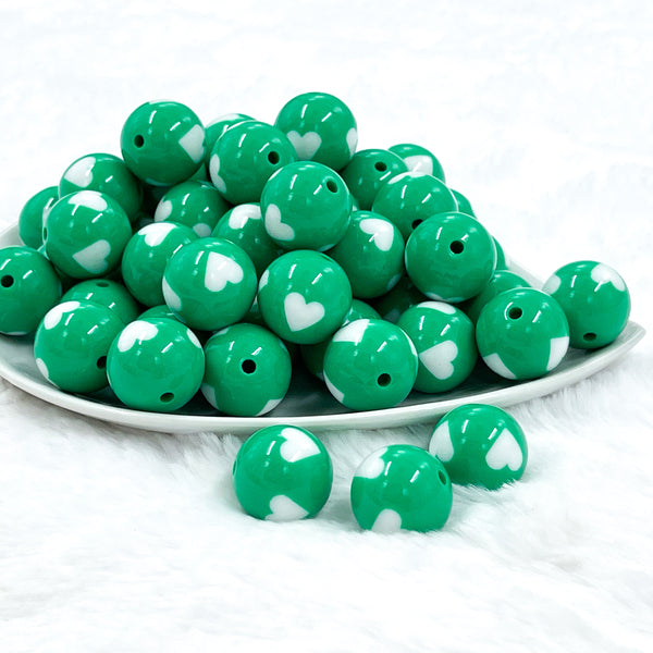 front view of a pile of 20mm Green with White Hearts Chunky Acrylic Bubblegum Beads