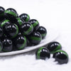 front view of a pile of 20mm Green Band on Black Bubblegum Beads