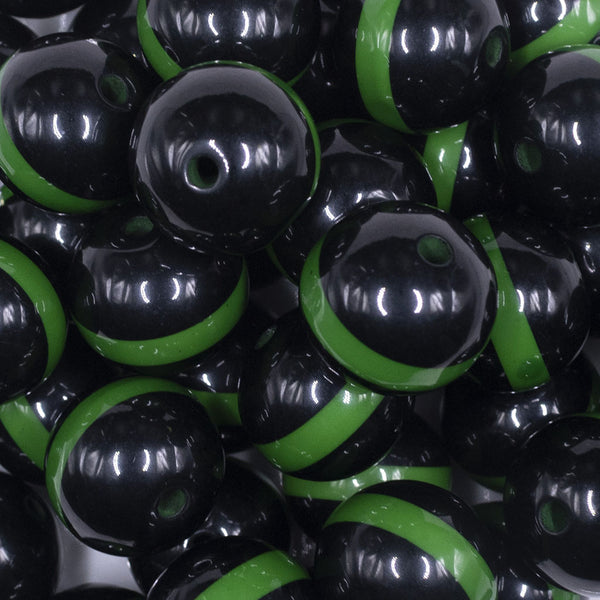 close up view of a pile of 20mm Green Band on Black Bubblegum Beads