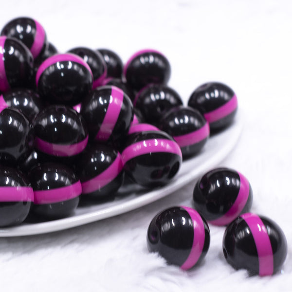 front view of a pile of 20mm Hot Pink Band on Black Bubblegum Beads