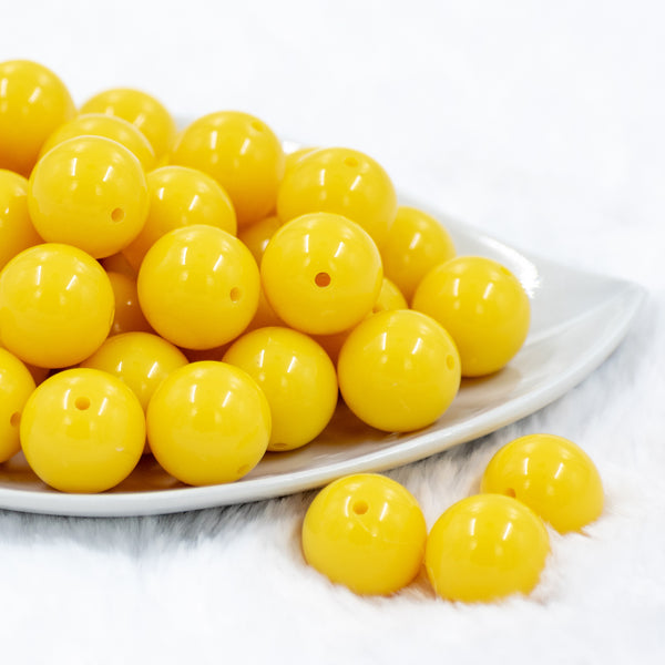 front of a pile of 20mm Lemon Yellow Solid Bubblegum Beads