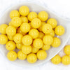 top of a pile of 20mm Lemon Yellow Solid Bubblegum Beads