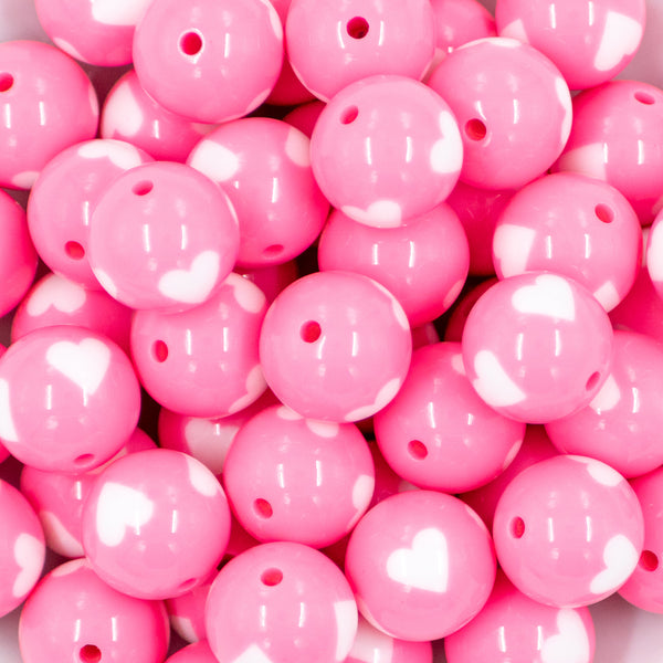 close up view of a pile of 20mm Cotton Candy Pink with White Hearts Acrylic Bubblegum Beads