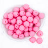 top view of a pile of 20mm Bubblegum Pink beads featuring a rhinestone covered surface pictured on a white dish and white background