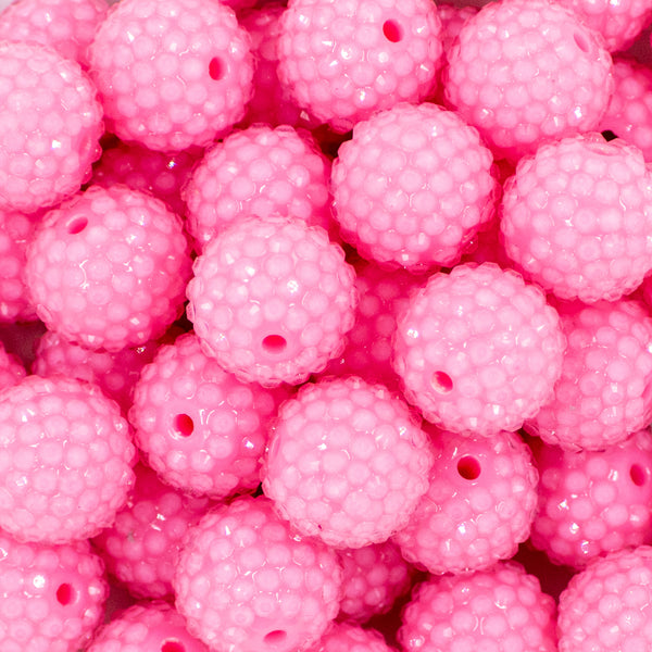 close-up of a pile of 20mm Bubblegum Pink beads featuring a rhinestone covered surface
