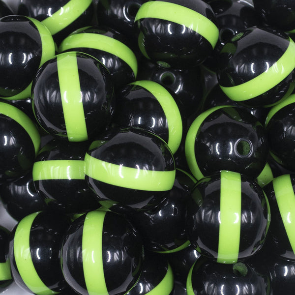 close up view of a pile of 20mm Lime Green Band on Black Bubblegum Beads