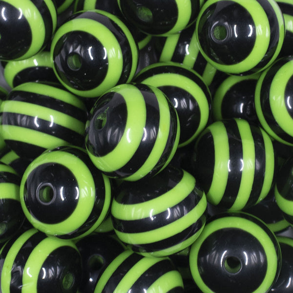 close up view of a pile of 20mm Lime Green Stripes on Black Chunky Bubblegum Jewelry Beads