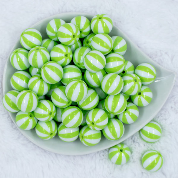 Top view of a pile of 20mm Lime Green with White Stripe Beach Ball Acrylic Chunky Bubblegum Beads