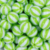Close up view of a pile of 20mm Lime Green with White Stripe Beach Ball Acrylic Chunky Bubblegum Beads