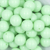 Close up view of a pile of 20mm Mint Green Solid Chunky Acrylic Bubblegum Beads