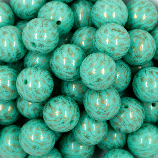 Close up view of a pile of 20mm Mint Green with Gold Arrows Print Chunky Bubblegum Beads