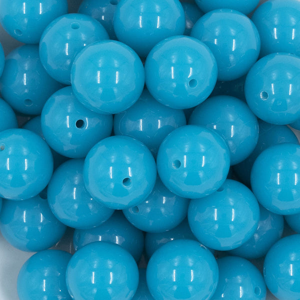 Close up view of a pile of 20mm Neon Blue Solid Acrylic Chunky Bubblegum Beads