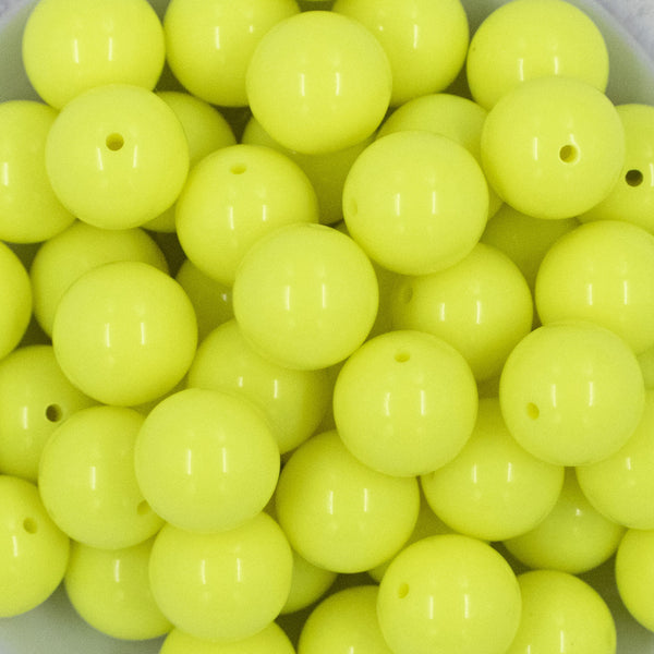 Close up view of a pile of 20mm Neon Yellow Solid Chunky Acrylic Bubblegum Beads