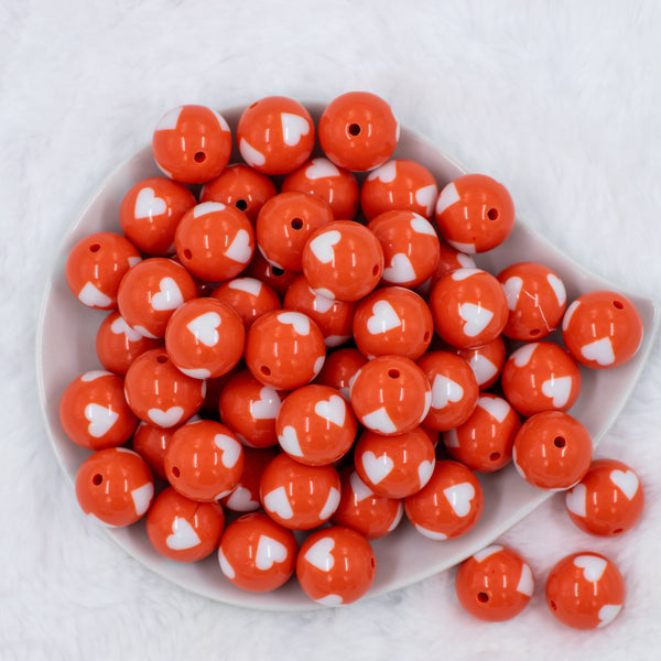 top view of a pile of 20mm Orange with White Hearts Bubblegum Beads