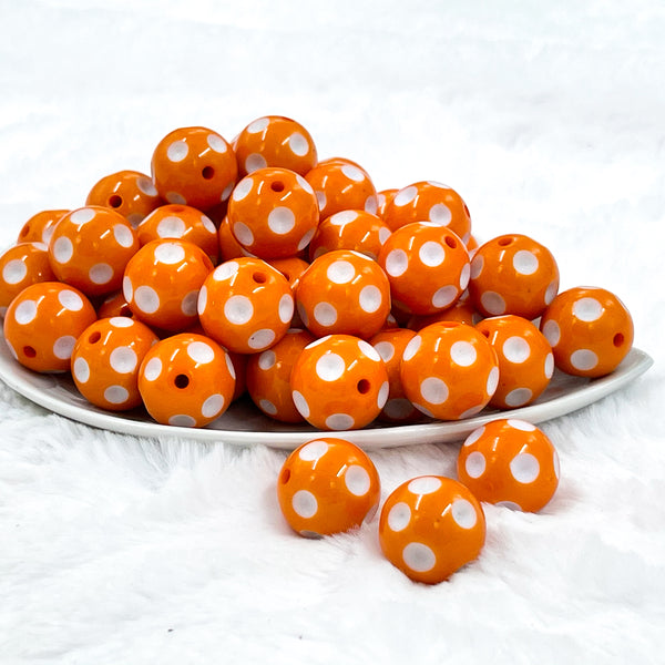front view of a pile of 20mm Orange with White Polka Dots Acrylic Bubblegum Beads